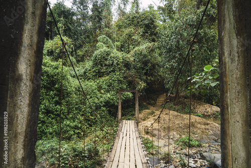 Old grungy wooden bridge in woods