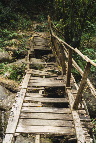 Old grungy wooden bridge in woods