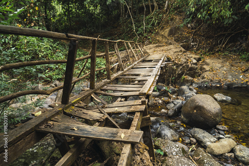 Old grungy wooden bridge in woods