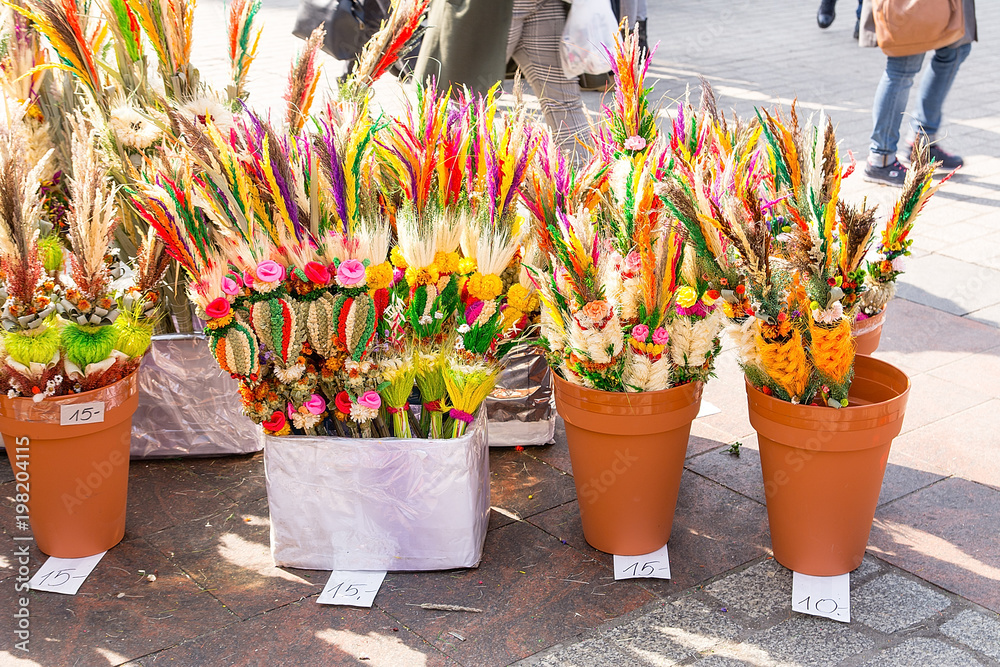 Traditional easter palms sold on market square in Krakow (Poland)