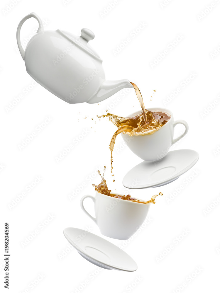 teapot pouring tea into flying cups, on white background Stock Photo