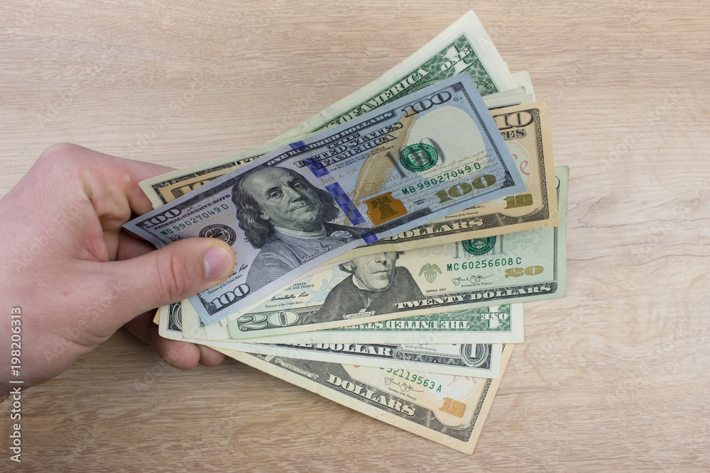 Mens hand holding banknotes. Background with money Mens hand holding banknotes. Background with money