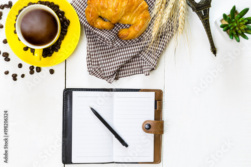 top view business breakfast with coffee and croussant. Rustic white wooden background with copy space photo