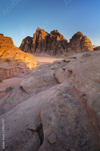 three rocks in sunset lights in desert in Jordan