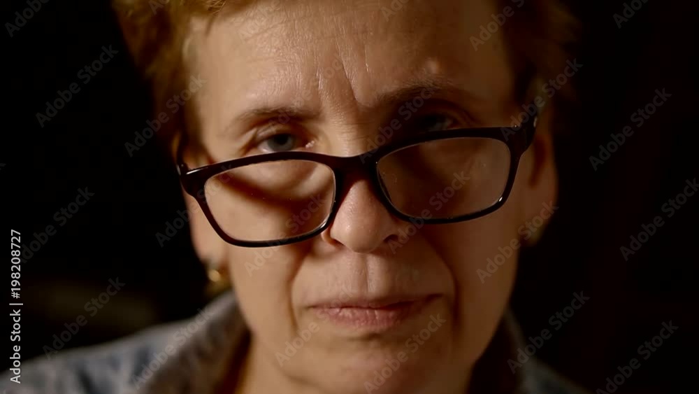 Close up. Portrait of an old elderly woman in plastic glasses dark frame. Close up. Portrait of an old elderly woman in plastic glasses dark frame.