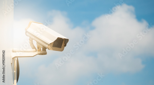 CCTV camera in security system in urban city with sky background in security concept,Soft focus with sun light.