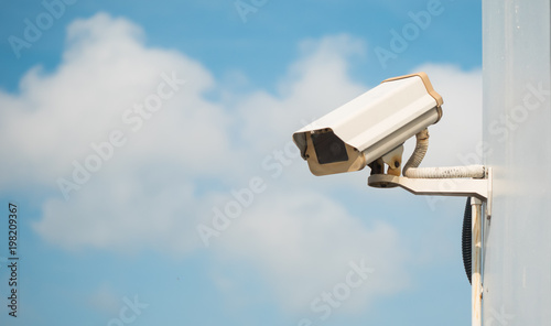 CCTV camera in security system in urban city with sky background in security concept