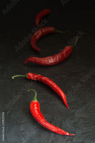 Pods of red hot pepper on a dark background