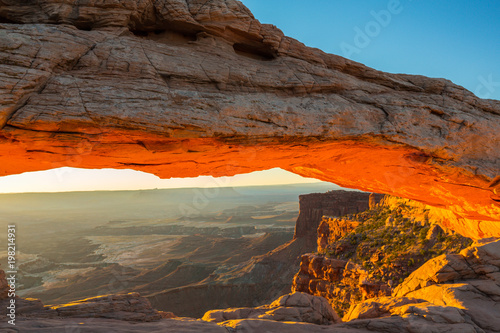 Beautiful Canyonlands view  from Mesa Arch  under warm surise light  on a clear autumn day