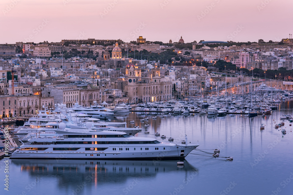 Birgu at evening and luxury yachts in harbor,Malta