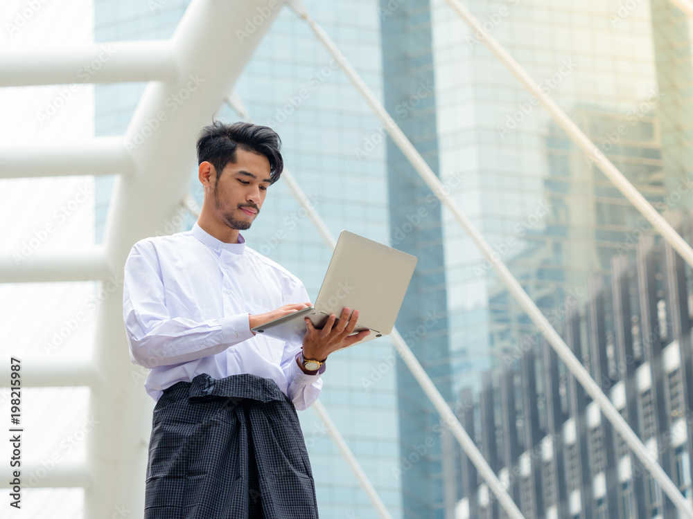 Young Burmese businessman find data in laptop ,It's time to talk about business Young Burmese businessman find data in laptop ,It's time to talk about business