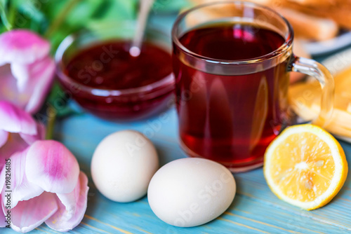 Breakfast with tea, jam and flowers