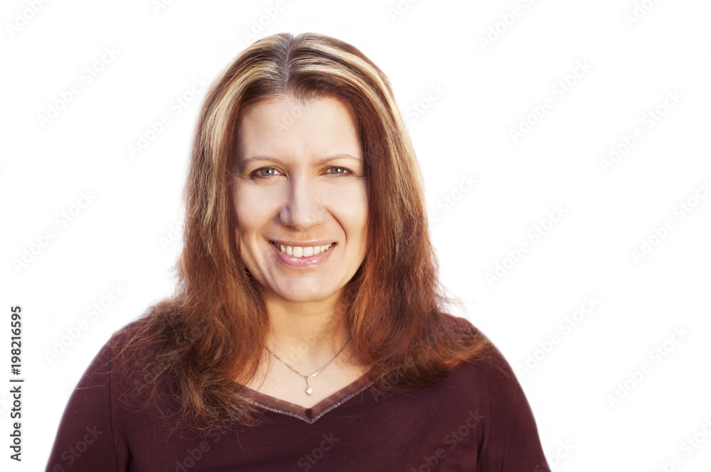 A beautiful middle-aged woman smiles on a white background. Her face shines with joy and positivity A beautiful middle-aged woman smiles on a white background. Her face shines with joy and positivity
