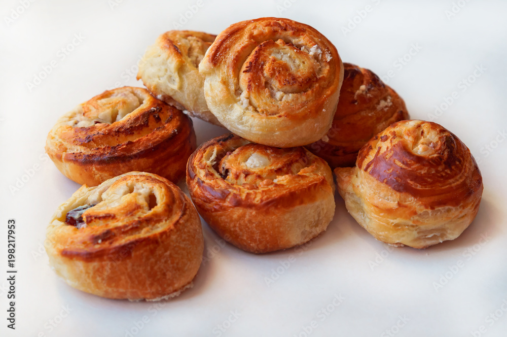 Buns of puff pastry. Curly buns with cheese. Cheese baked puff pastry.