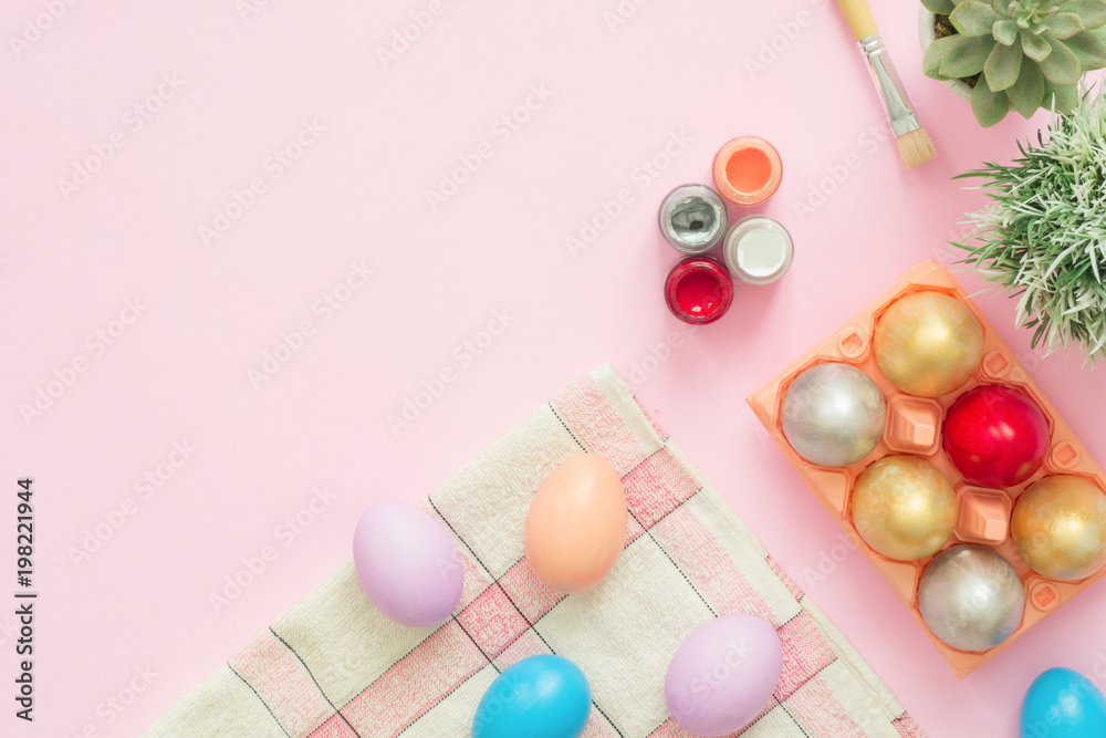 Flat lay top view colorful easter egg painted in pastel colors composition with paint brush on pink pastel color background. Easter day background top view with copy space. Flat lay top view colorful easter egg painted in pastel colors composition with paint brush on pink pastel color background. Easter day background top view with copy space.