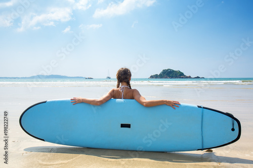 girl with surfboard resting