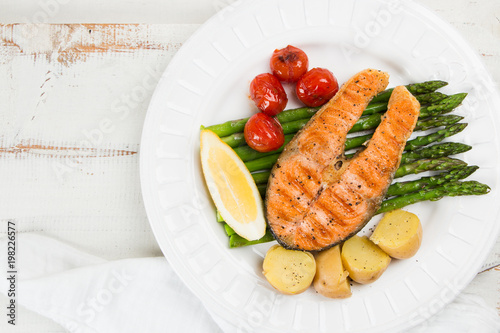 Grilled salmon with green asparagus, cherry tomato and potatoes