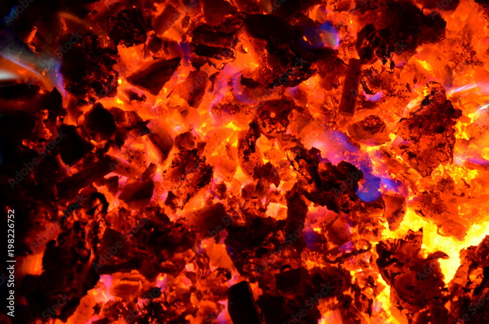 Violet tongues of flame from burning non-ferrous metals break through the hot coal.
Violet tongues of flame from burning non-ferrous metals break through the hot coal.