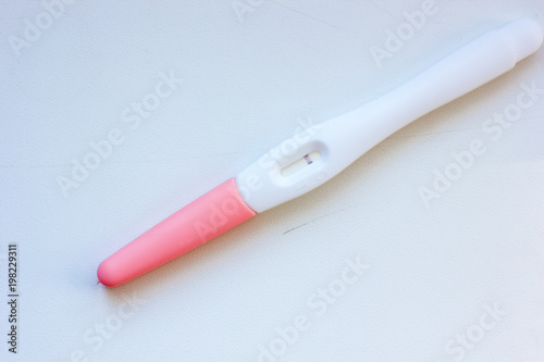 Negative pregnancy test on white table.