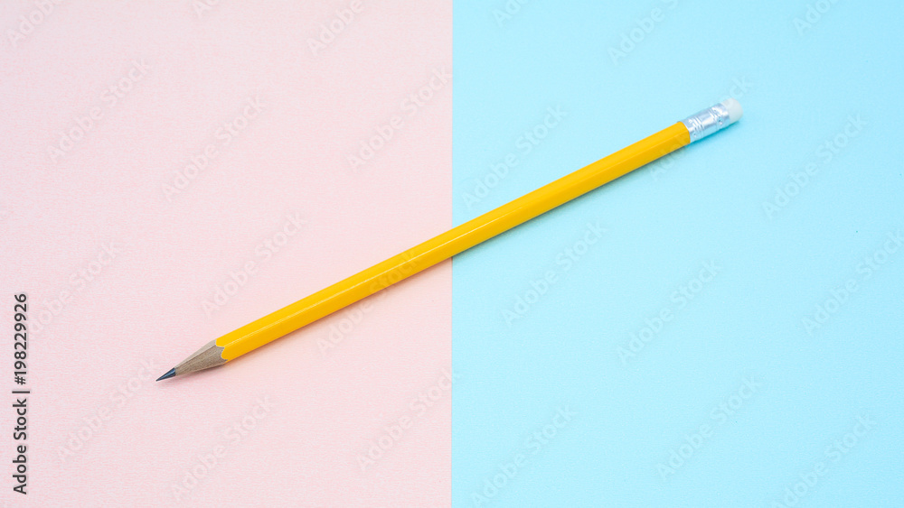 yellow pencil on pink and blue paper - background yellow pencil on pink and blue paper - background