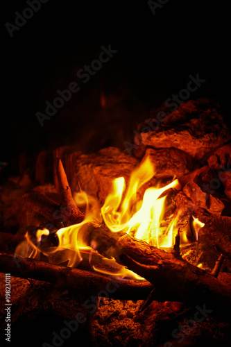 Flame on a black background in natural conditions at night.