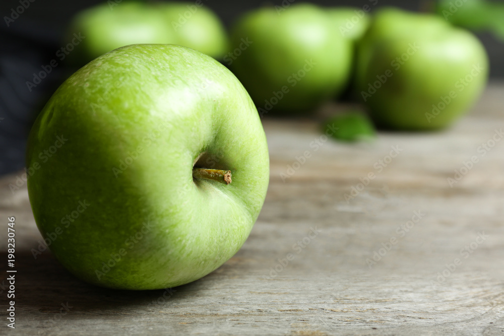 Fresh green apple on wooden table, closeup Fresh green apple on wooden table, closeup