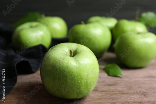 Fresh green apples on wooden table
