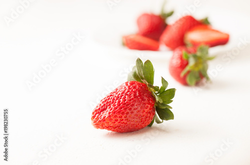 Ripe red strawberry on white table
