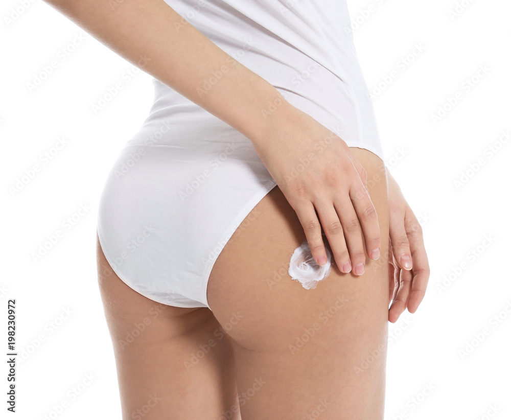 Young woman applying body cream on white background Young woman applying body cream on white background