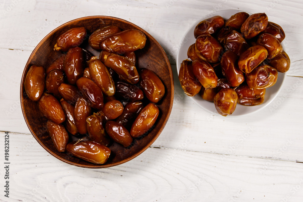 Dried dates fruit on white wooden table. Top view Dried dates fruit on white wooden table. Top view