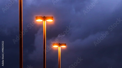 Parking lot lights and dark clouds - time lapse