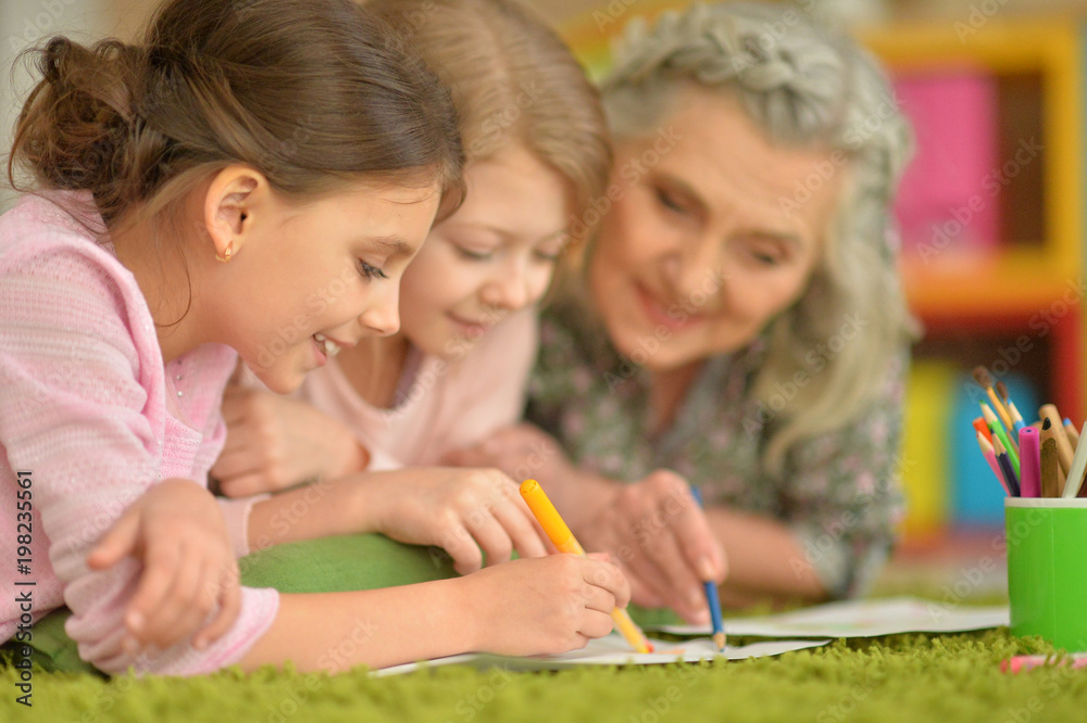 Fototapeta premium grandmother and granddaughters doing homework