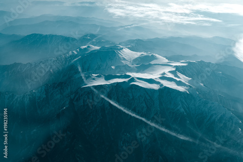 A winter mountain view from plane window photo