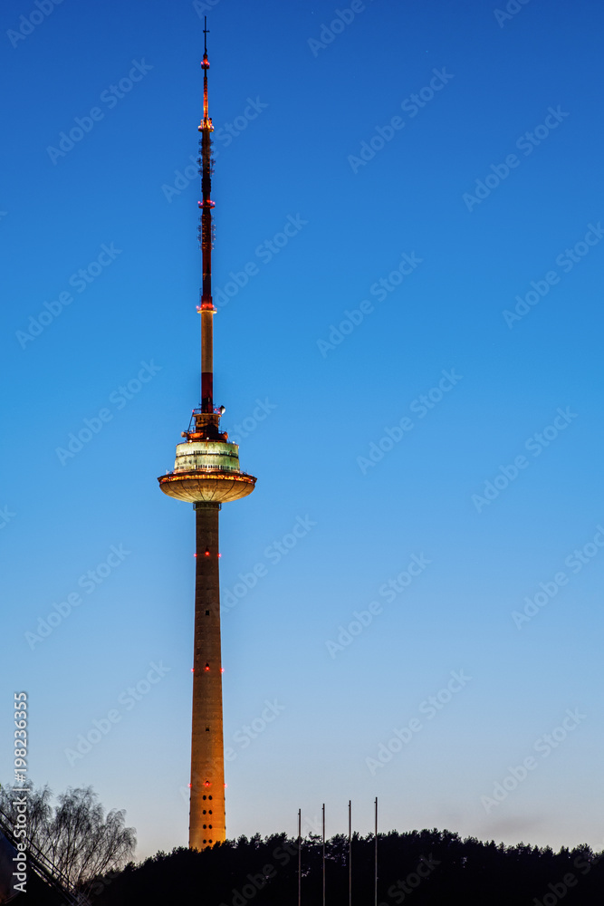 Vilnius TV Tower -- the tallest structure in Lithuania -- at night on the clear blue sky background