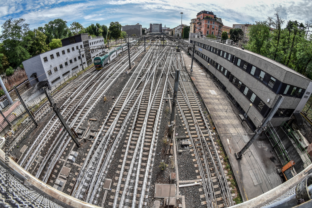 Railroad station with multiple roads intersecting and converging in Milan, Italy, Europe