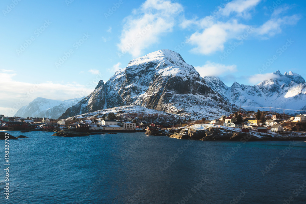 Naklejka premium Beautiful super wide-angle winter snowy view of fishing village A, Norway, Lofoten Islands, with skyline, mountains, famous fishing village with red fishing cabins, Moskenesoya, Nordland