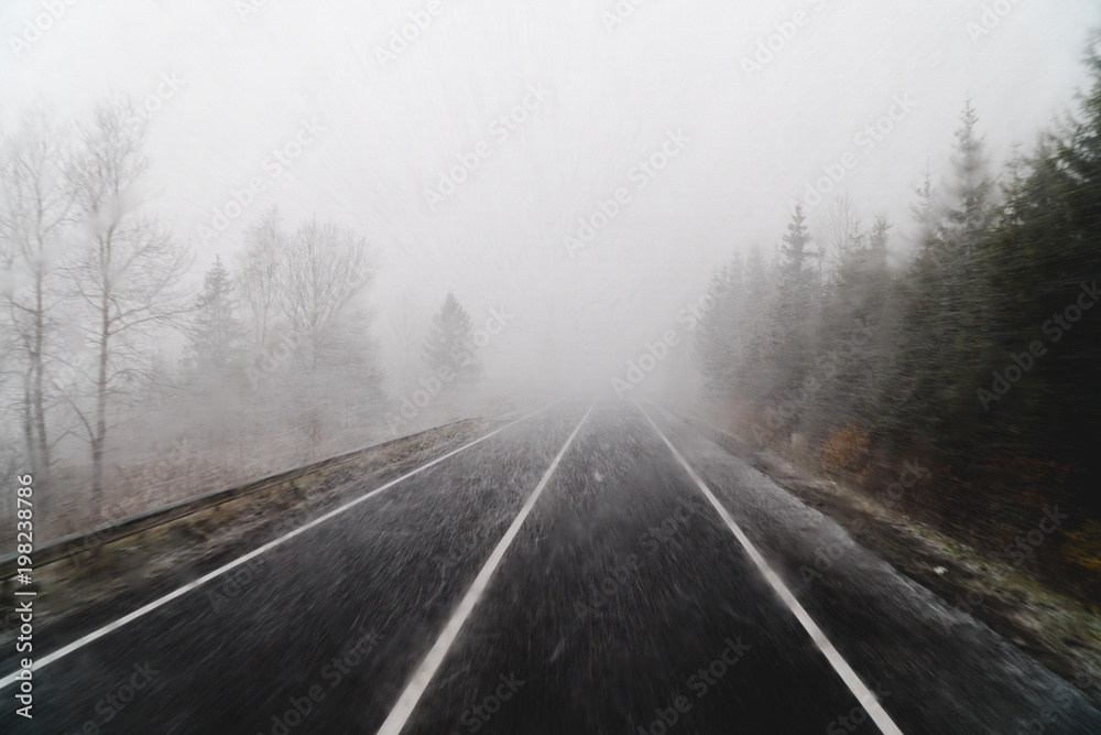 Blurry dangerous car overtaking on highway at heavy snowy conditions. traffic situation, marks, Problems Blurry dangerous car overtaking on highway at heavy snowy conditions. traffic situation, marks, Problems