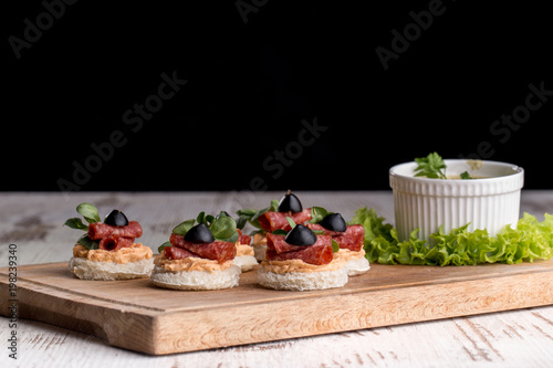 Canapes with salami and olives