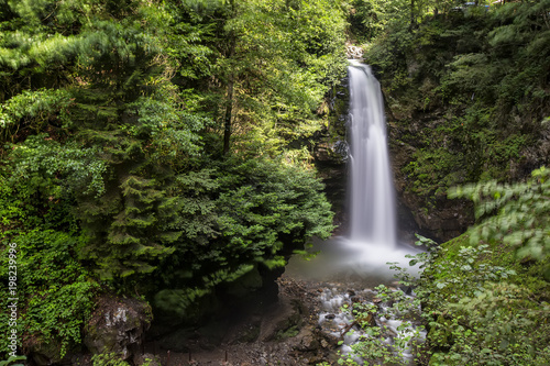 Fototapeta Naklejka Na Ścianę i Meble -  Palovit Waterfall in Kaçkar Mountains National Park is one of the highest waterfalls of Rize. This famous waterfall in a lush green forest is about 15 meters high and foam poured into a creek bed.