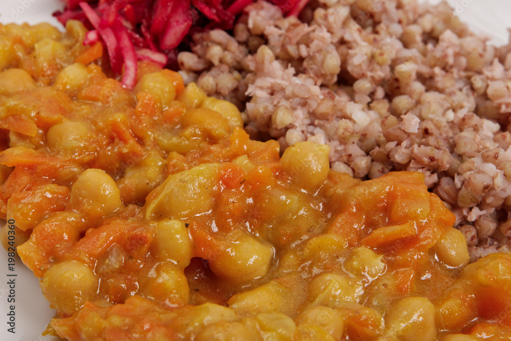 Stewed carrots with chickpeas and buckwheat on a table Stewed carrots with chickpeas and buckwheat on a table