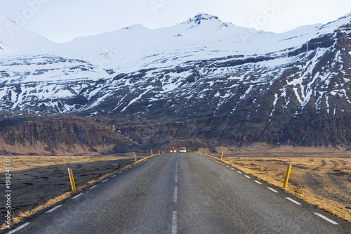 Icelandic road with volcanic snow covered mountains in wintertime, Iceland