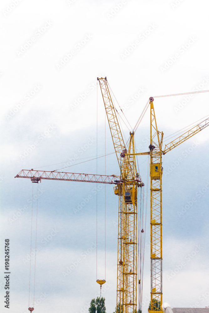 Building crane under construction against blue sky