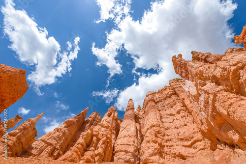 Hoodoos in the Sky - Colorful sandstone hoodoos, against bright blue sky and white clouds, at Queens Garden of Bryce Canyon National Park, Utah, USA.