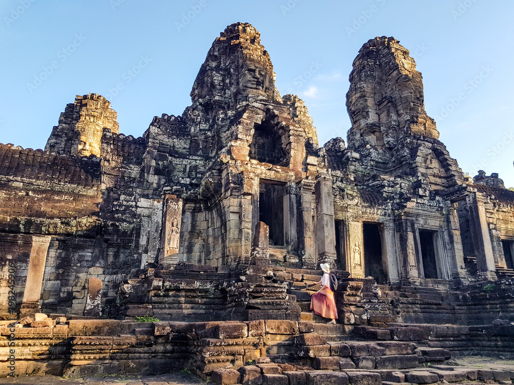 Fototapeta premium Woman tourist in Bayon temple in Angkor Wat