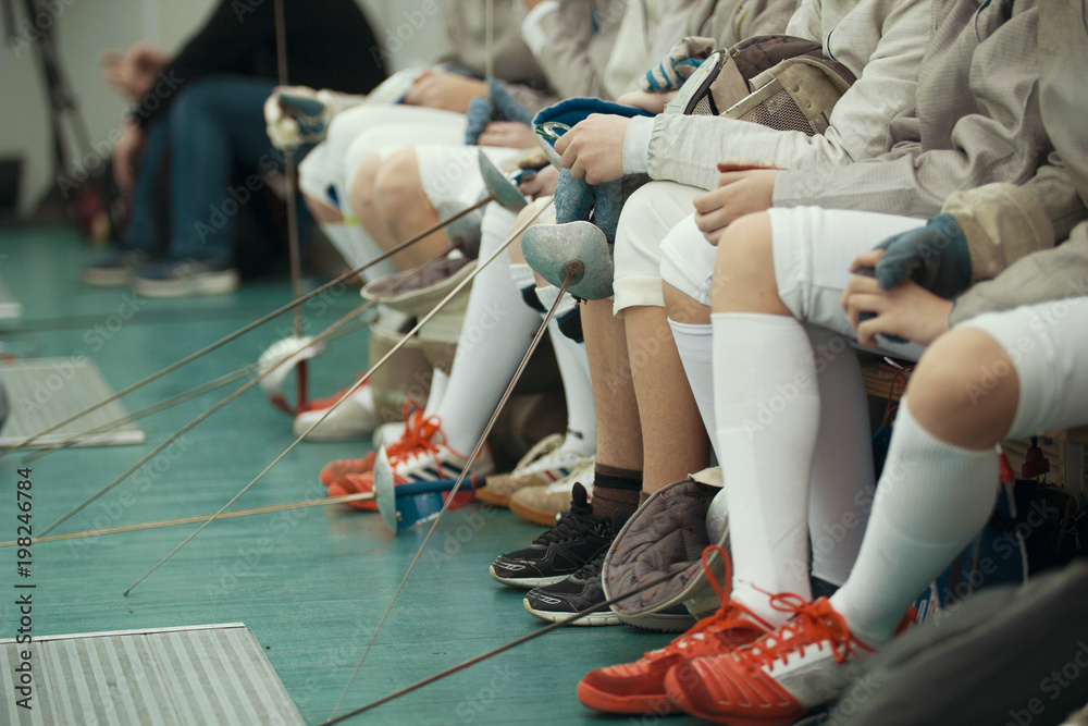 Legs of young participants of fencing competition