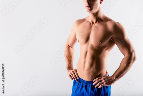 Cropped close up photo of ideal perfect muscular slender man, he has rock-hard six-pack, isolated om grey background, copy-space