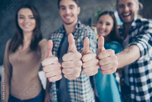 Close up portrait of four thumbs up from cheerful, joyful friends, two couples, colleagues on the blurred background in office, work place, station