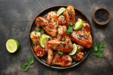 Grilled teriyaki chicken wings with black sesame and lime.Top view.