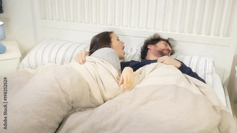 Cute couple in the morning happy playing with dog in bed Cute couple in the morning happy playing with dog in bed