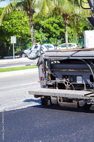 Pavement truck laying fresh asphalt